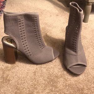 Gray heeled booties with stretchy cloth material